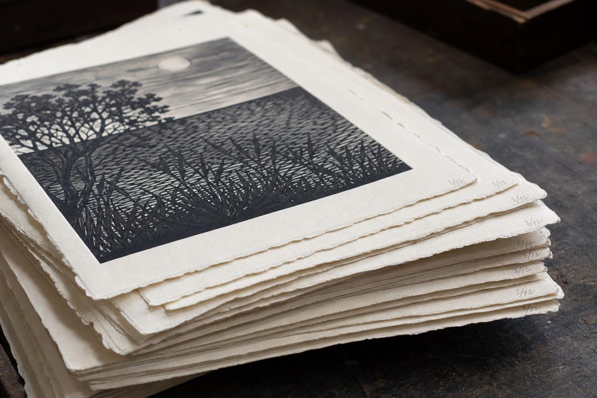 Stack of limited edition linocut prints on cotton paper